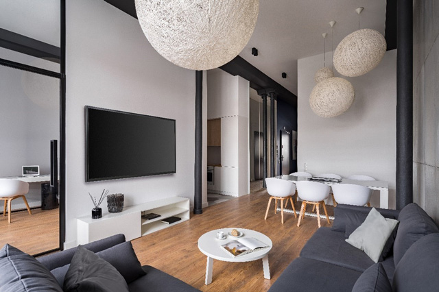 salon cosy avec canapé gris et télévision accrochée au mur